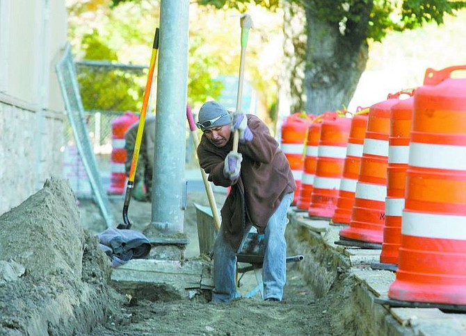 BRAD HORN/Nevada Appeal A construction worker digs in the sidewalk area of the Ormsby House on Fifth Street on Wednesday morning. The owner, Don Lehr, says the sidewalks may be ready for the Nevada Day Parade.