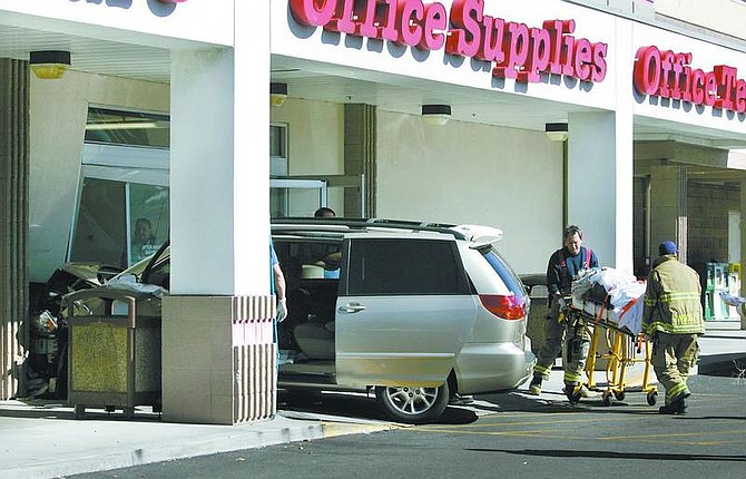 Cathleen Allison/Nevada Appeal A Carson City couple was transported to Carson Tahoe Regional Medical Center on Wednesday afternoon after their car crashed into the front doors of Office Depot. The driver, a 71-year-old Carson City man, apparently lost consciousness due to a medical problem.