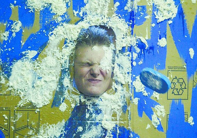 BRAD HORN/Nevada Appeal Eddie McMillan, 15, gets hit in the face with a whipped cream sponge at a carnival at Virginia City Middle School.