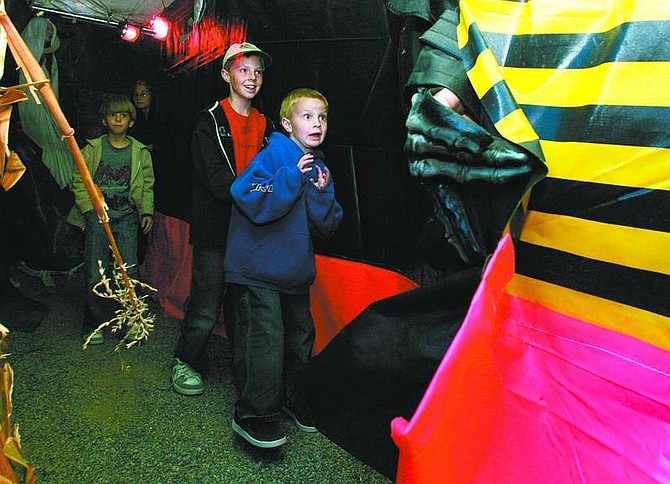 BRAD HORN/Nevada Appeal Logan Thomassen, 6, in front, Landen Thomassen, 10, and Hayden Thomassen, 8, go through the Tent of Terror, which continues this weekend, in Dayton.