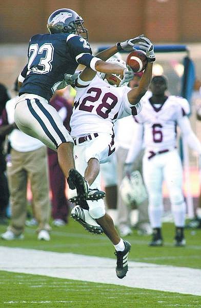 Nevada&#039;s Joe Garcia breaks up a pass to New Mexico State&#039;s Chris Williams in the third quarter of Saturday&#039;s game, Oct. 28, 2006 in Reno, Nev. Nevada won 48-21. (AP Photo/Cathleen Allison)