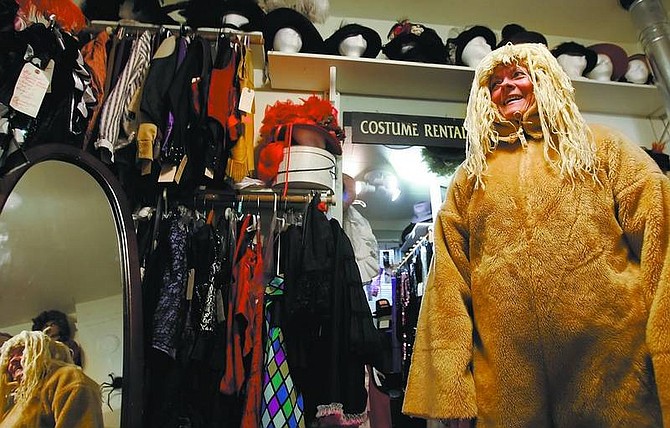 Chad Lundquist/Nevada Appeal Susan Secoy, a real estate agent from Carson City, tries on a horse costume Monday at Revelations costume rental and portrait studio on North Curry Street. She was seeking help for a way to transform the horse into a donkey.
