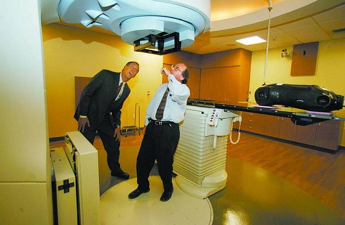 BRAD HORN/Nevada Appeal Oncologists John Kelly, right, and Mark Meadors look at a Linear Accelerator during a media tour of the Carson Tahoe Cancer Center on Wednesday. The center will be open for public tours Saturday.