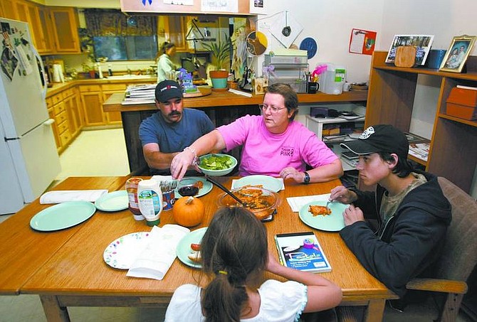 Cathleen Allison/Nevada Appeal Breast cancer survivor Penny Russell and her husband, Pete, have dinner with their kids, Kimmi, 13, at rear, Kyle, 15, and Melissa, 9.