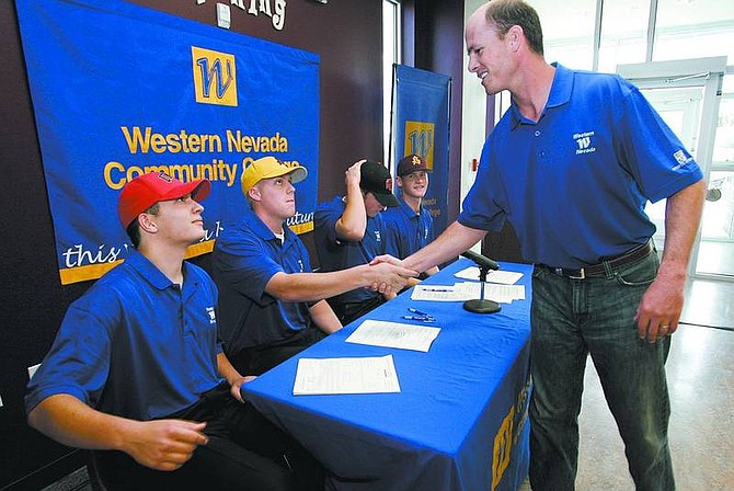 Cathleen Allison/Nevada Appeal Wildcat baseball Coach D.J. Whittemore, right, congratulates players, from left, Justin Garcia, Cole Rohrbough, Dan Grubbs and Stephen Sauer, who all signed letters of intent to Division I schools at Western Nevada Community on Wednesday afternoon.