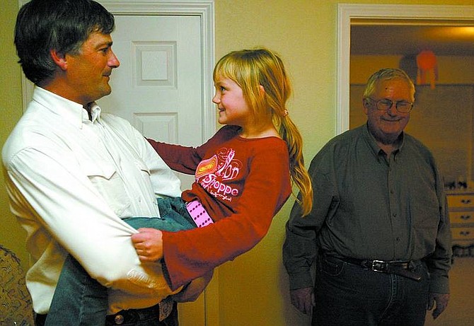 Shannon Litz/Appeal News Service Assembly District 39 candidate James Settelmeyer with his daughter, Caitlyn, 6, and father, Arnold Settelmeyer at home on election night. The third-generation Carson Valley rancher won election for the seat previously held by retired Assemblyman Lynn Hettrick.