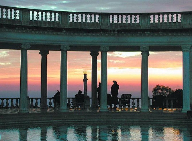 photos by Kelli Du Fresne Living history actors mingle around the deck of the Neptune Pool at Hearst Castle as the sun sinks over the Pacific Ocean.