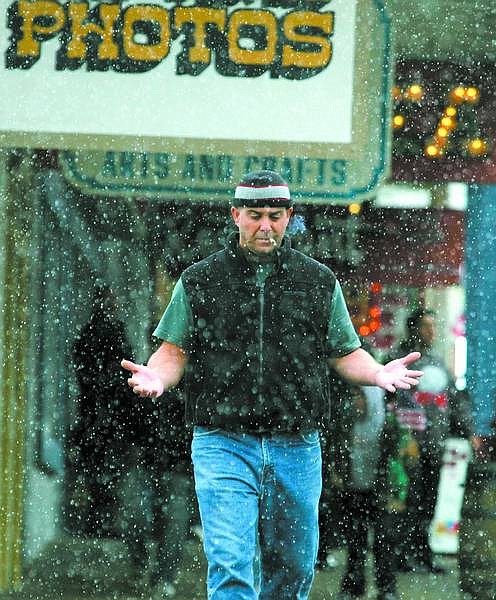 BRAD HORN/Nevada Appeal Guy Ruiz, of Reno, walks through a light snow storm in Virginia City after the Veterans Day parade Saturday morning. Ruiz recently moved from Kauai Waimea, Hawaii, where he was born.
