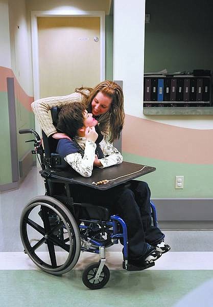 Chad Lundquist/Nevada Appeal Julie Sawyer shares a moment with Mary, a client at the Eagle Valley Children&#039;s Home on Wednesday. Sawyer works part-time at the home for disabled children and adults while attending college to become a nurse.