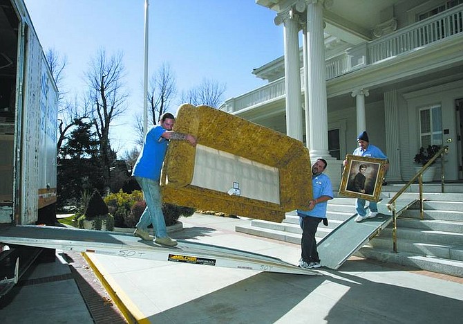 Cathleen Allison/Nevada Appeal United movers, from left, Jason Walker, Robert Walker and Hector Cardenas, load items at the Governor&#039;s Mansion on Thursday as first lady Dema Guinn has the first of at least three loads of belongings moved to their Las Vegas and Reno homes. The Guinns will complete the move after spending their last Christmas with their grandchildren in the mansion, where they have lived for the past eight years.