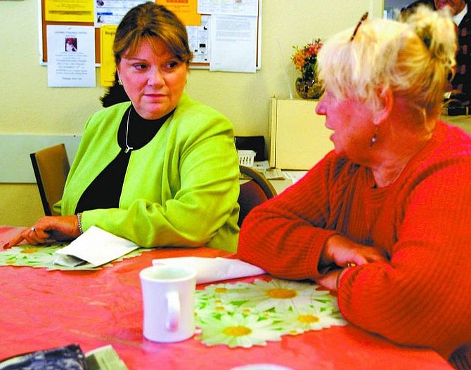 Emma Garrard/Nevada Appeal News Service Margaret Reilly, left, program manager for the Health Insurance Counseling and Advocacy Program, talks with Truckee resident Denise Dorris about the Medicare drug program at the Truckee Senior Center Monday morning. Seniors need to apply by Dec. 31 to get coverage for 2007.