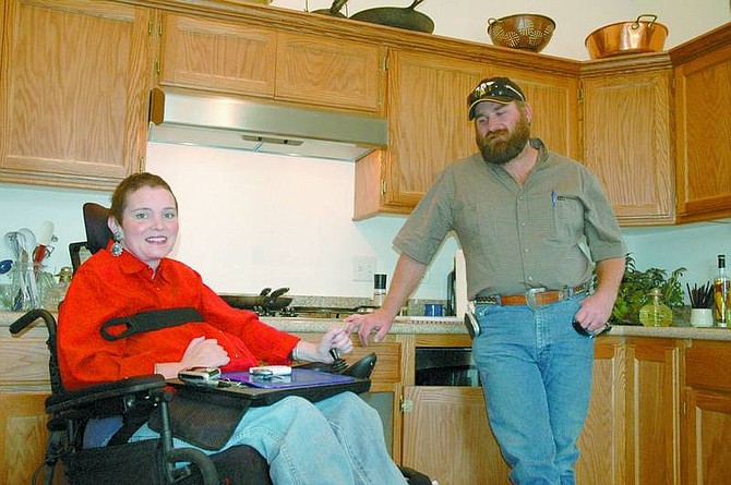 Christy Lattin/Nevada Appeal News Service Kerry and Harley Capps enjoy the kitchen in their renovated home. Kerry was left a quadriplegic following a car accident last year. The couple&#039;s existing home wasn&#039;t suitable for her wheelchair. Louie Mori and the Churchill County High School construction class completely renovated the home, making it completely accessible for Kerry.