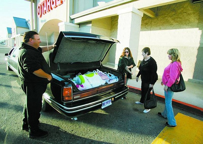 BRAD HORN/Nevada Appeal John Bolin gets ready to shut the limousine&#039;s trunk after Michelle Krick, from left, Misty Jordan, and Pam McGrath finished shopping at Target on Friday morning. The three Carson City women began their shopping day at 3:45 a.m. at Wal-Mart.
