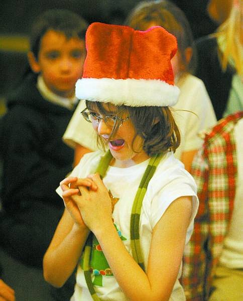 BRAD HORN/Nevada Appeal Katie Matuska, 8, a third-grade student at St. Teresa of Avila Catholic School, gets ready to rehearse the shopper scene of the Christmas play on Thursday.