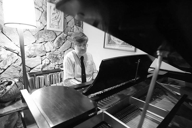 BRAD HORN/Nevada Appeal David Bugli warms up on his piano in his Carson City home on Thursday. Bugli received a Governor&#039;s Arts Award for Distinguished Service to the Arts.