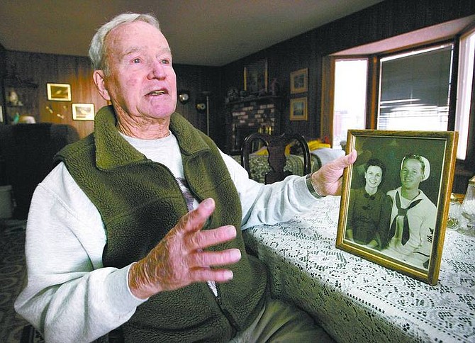 Cathleen Allison/Nevada Appeal Pearl Harbor veteran Morton &quot;Pat&quot; Frey talks about his experiences 65 years ago at Kaneohe Naval Air Station from his North Carson City home Wednesday morning. Frey holds a picture of him and his wife, Katy, taken before World War II started.