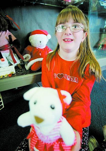 BRAD HORN/Nevada Appeal Emma Baggio, 9, displays one of the teddy bears for sale at Seeliger Elementary School&#039;s auction fundraiser.