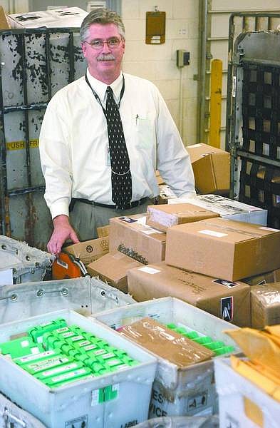 Cathleen Allison/Nevada Appeal Carson City Postmaster Jerry DePaoli, seen Monday in the shipping area of the Roop Street post office, offers some advice for getting packages delivered in time for Christmas.
