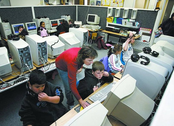 Substitute teacher Cindy DeHaven works with Kelli Tanzi&#039;s fourth-grade class in the computer lab at Dayton Elementary School on Friday. Lyon County School officials are prioritizing repairs and maintenance needs for schools.  Cathleen Allison/ Nevada Appeal
