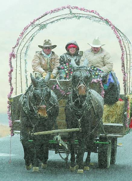 BRAD HORN/Nevada Appeal Ron Miarecki, from right, E.T. Thomas, and Jerry Myers, ride through a snowstorm at Washoe Lake State Park during the Cowboy Christmas celebration on Saturday.