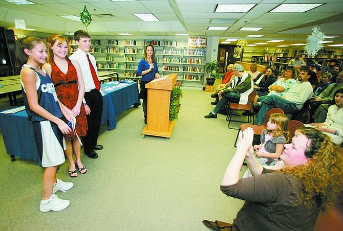 BRAD HORN/Nevada Appeal Janet Butler, left, poses for a picture with C-Unity co-chairpeople Molly Champion and Bryan Byrne during an awards ceremony in the Carson High School library.