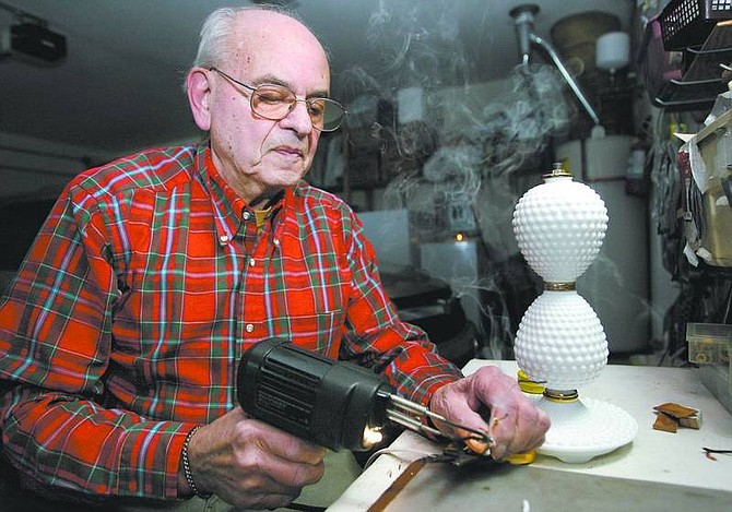 Norman Greenspan rewires a milk-glass lamp at his North  Carson City home  Tuesday. Greenspan and his wife, Judy, have run their Lamp Doctor business for five years.  Cathleen Allison/ Nevada Appeal
