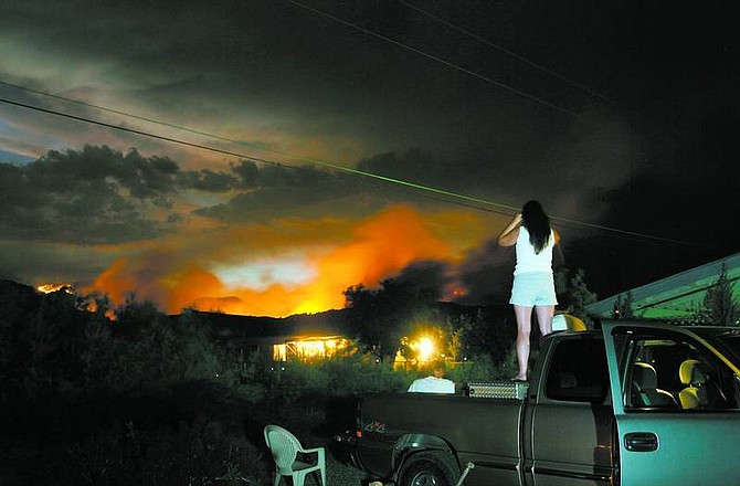 Residents on Six Mile Canyon Road watch the Six Mile 2 fire burn about a mile from their homes on July 22.  Brad Horn/ Nevada Appeal