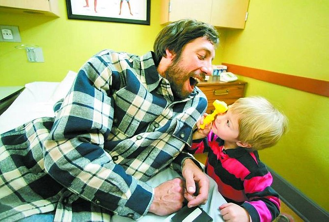 BRAD HORN/Nevada Appeal Eric Boroughs, of Stateline, plays doctor with his daughter Nesta, 3, at the Children&#039;s Museum of Northern Nevada on Saturday.