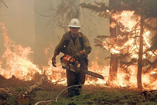 AP Photo/Press Democrat, John BurgessJimmie Fox, with the Mendocino National Forest hand crew, runs away from the Angora fire while clearing fuel near homes in South Lake Tahoe earlier today.