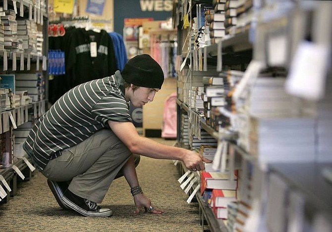 Cathleen Allison/Nevada AppealStefan Jensen restocks some of the more than 8,000 new and used books available at the Western Nevada College bookstore Wednesday afternoon. School officials say more than 1,000 different classes will begin Monday at the college&#039;s three different campuses and five learning centers.