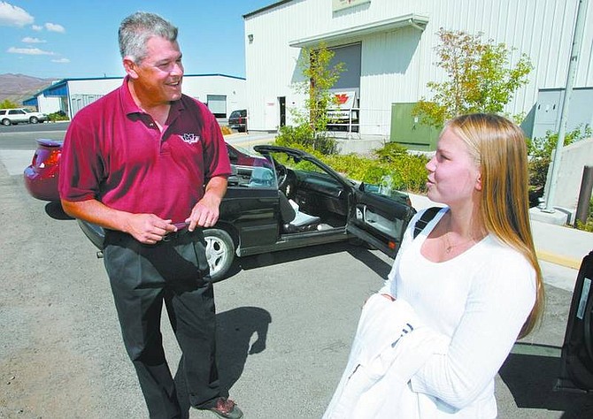 Cathleen Allison/Nevada AppealReagan Rivera, with VCM Collision Center, talks with Amber Gafford, 16, Tuesday afternoon after he installed a DriveCam in her car. The device, provided by her family&#039;s insurance company, is part of a pilot program to reduce risky teen driving behavior.