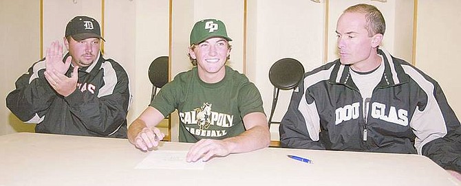 Sarah Hall/Nevada Appeal News ServiceDouglas High School coach John Glover, left, and athletic director Jeff Evans looked on as senior Jordan Hadlock signed his commitment to play baseball for the Cal Poly Mustangs this afternoon.