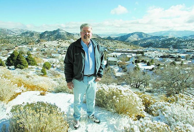 BRAD HORN/Nevada Appeal Mike Nevin, the new Storey County Public Works director, stands in front of a snow-covered Virginia City on Dec. 22.
