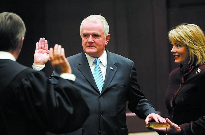 Chad Lundquist/Nevada Appeal Jim Gibbons with his wife, Dawn, holding the Bible, is sworn in as Nevada&#039;s 29th governor on New Year&#039;s Day by Chief Justice Bill Maupin in the chambers of the Nevada Supreme Court. Citing security concerns, Gibbons was officially sworn in for the first time as Nevada governor seconds after the New Year at his home in Reno.