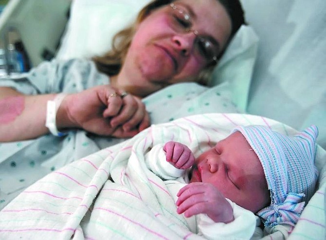 photos by Chad Lundquist/Nevada Appeal Paula McMillen holds her daughter, Felicia Lorraine, on Tuesday afternoon at Carson Tahoe Regional Medical Center. The 6-pound, 8-ounce baby girl was born at 8:05 a.m. Tuesday to Paula and Jason McMillen, making her the first baby of 2007 at the hospital.