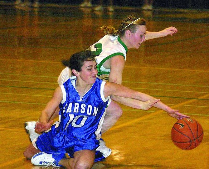 DAVID RANSON/Appeal News Service Guards Megan Kitty of Carson, left, and Olie Fowler of Fallon fight for a loose ball during the first half of their non-league basketball game in Fallon.