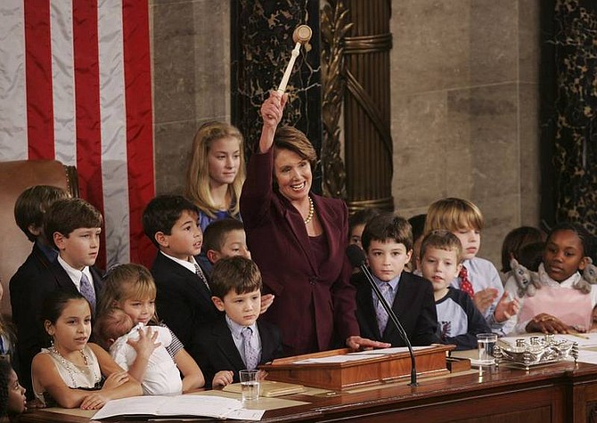 AP Photo/Susan Walsh Newly elected Speaker of the House Nancy Pelosi, D-Calif., holds up the gavel surrounded by the children and grandchildren of members of Congress in the U.S. Capitol in Washington, D.C., on Thursday. The blond girl behind Pelosi in the blue dress is Emmy Heller, 11. When Pelosi called the children in the chamber to join her at the podium for a chance to touch the gavel, Emmy quickly went down from her seat. Her dad Dean Heller, R-Nev., says one of the representatives behind him joked, &quot;Hey, don&#039;t let her go down there.&quot; Heller told him, &quot;it&#039;s OK. I told her to go get the gavel and bring it back.&quot; Heller&#039;s parents, Janet and Jack Heller, and his brother Bryan Heller were seated in the gallery. An additional 12 family members watched the proceedings on the TV in Dean&#039;s office.