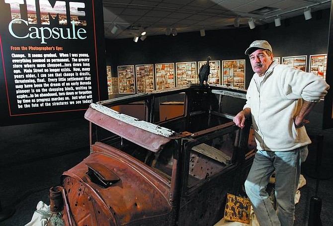 Chad Lundquist/Nevada Appeal Photographer Robert Cinkel stands near his exhibit, titled &quot;Time Capsule: The Back Roads of Northern Nevada,&quot; on Wednesday. The exhibit is on display at the National Automobile Museum in Reno through June 11.
