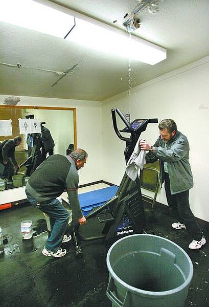 Cathleen Allison/Nevada Appeal Carson City School District workers move gym equipment after a broken sprinkler line began leaking at Eagle Valley Middle School on Tuesday afternoon. Freezing temperatures have cause burst pipes throughout the area.