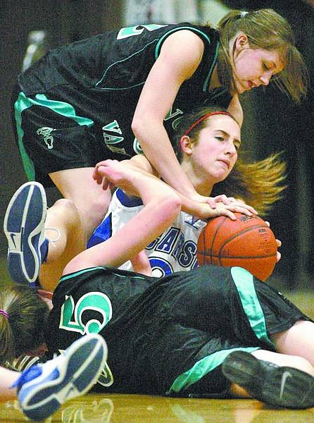 Cathleen Allison/Nevada Appeal Carson&#039;s Anna Macquarie wrestles with North Valleys players Helena Inskeep (55) and Sarah Finlay (32) in Friday&#039;s game at CHS.