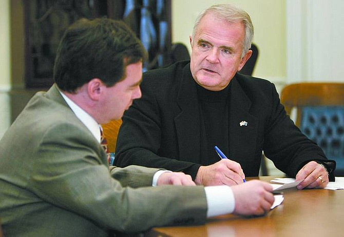 Cathleen Allison/Nevada Appeal Gov. Jim Gibbons works with his chief of staff, Mike Dayton, on Wednesday at the Capitol. Gibbons will present his State of the State address Monday evening, outlining his $7 billion budget plan.
