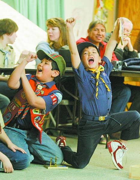 BRAD HORN/Nevada Appeal Zachary Frewert, 8, right, celebrates after winning a heat at Pack 143&#039;s pinewood derby at St. Paul&#039;s Church on Saturday. On the left is Frewert&#039;s brother Ricky, 9. Zachary placed first overall while Ricky took second.