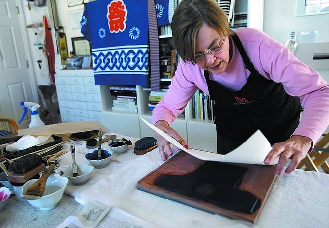 Chad Lundquist/Nevada Appeal Carol Brown works on a woodblock print in her studio on Wednesday. Brown recently received a Nevada Arts Council Jackpot Grant to pursue her artwork.