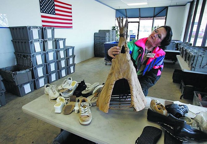 Chad Lundquist/Nevada Appeal Debbie Bedoy, employee for Goodwill Industries, looks over a wicker tee-pee at the donation center on South Carson Street on Monday. The nonprofit is seeking permission from planning commissioners to allow sale of secondhand goods at a store on North Carson Street.