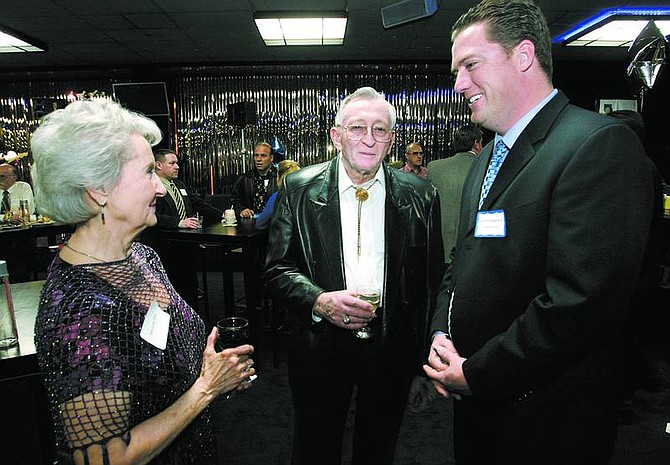 Cathleen Allison/Nevada Appeal Former Assembly Speaker Joe Dini, center, and his wife, Mouryne, talk with Assembly Majority Leader John Oceguera, D-Las Vegas, at the Carson Nugget Tuesday night. Officials from Carson City, Douglas, Lyon and Storey counties hosted the event to welcome lawmakers to town for the legislative session , which opened Monday.