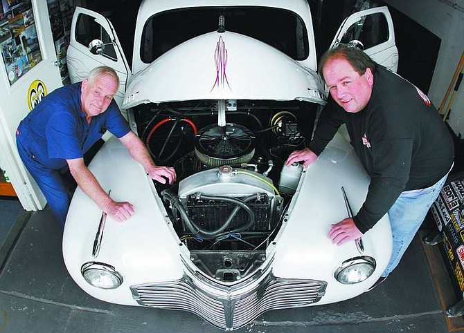 Trevor Clark/Nevada Appeal Father and son Tom (left) and Robby Shelton pose with a 1941 modified Chevrolet street rod that they had just finished working on at their shop Wednesday morning.