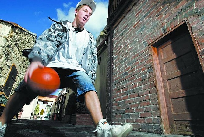 Chad Lundquist/Nevada Appeal Carson High&#039;s Will Holbert dribbles the ball through an ally way in downtown Carson on Sunday afternoon.