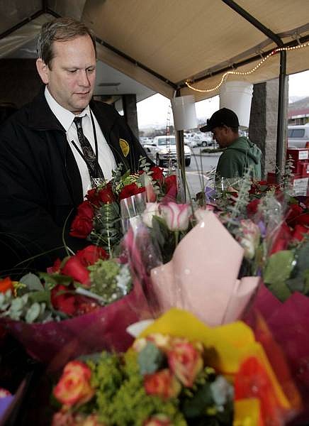 Doug Hval, 47, looks for the perfect bouquet of roses for his wife at Raley&#039;s on Wednesday on his way home from work. Raley&#039;s received about 96 dozen roses, and sold most of them to last-minute  shoppers.  Chad Lundquist /Nevada Appeal