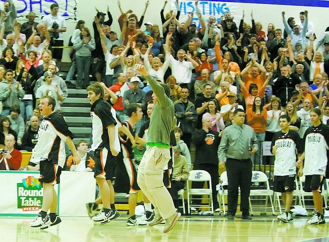 BRAD HORN/Nevada Appeal The Douglas Tigers basketball team and its crowd reacts after the Tiger&#039;s upset the Reno Huskies in their semi-final game at Spanish Springs on Friday.