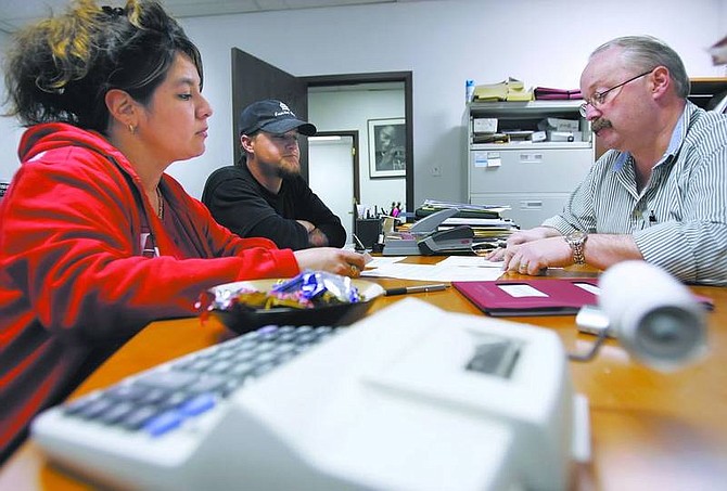 Chad Lundquist/Nevada Appeal Ernie Mayhorn, right, of Mayhorn Financial Services, works with Brian and Yvonne Anderson on Wednesday to prepare their tax returns for the year.